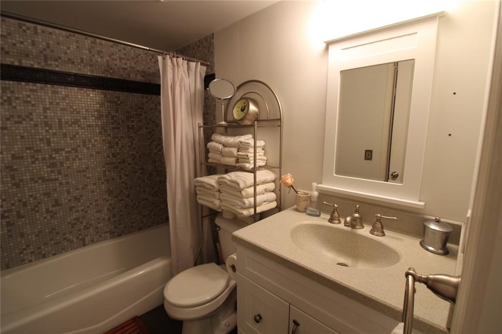 172 Haynes Street Southwest, Unit 208 Atlanta, GA 30313 - Photo 22 of 30 a bathroom with a sink toilet and shower