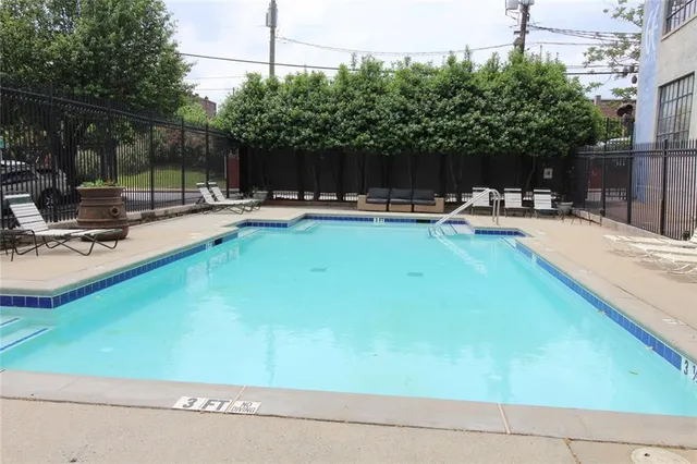 a view of swimming pool with chairs and tables