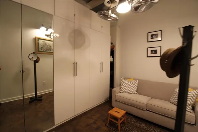 a living room with furniture and a walk in closet