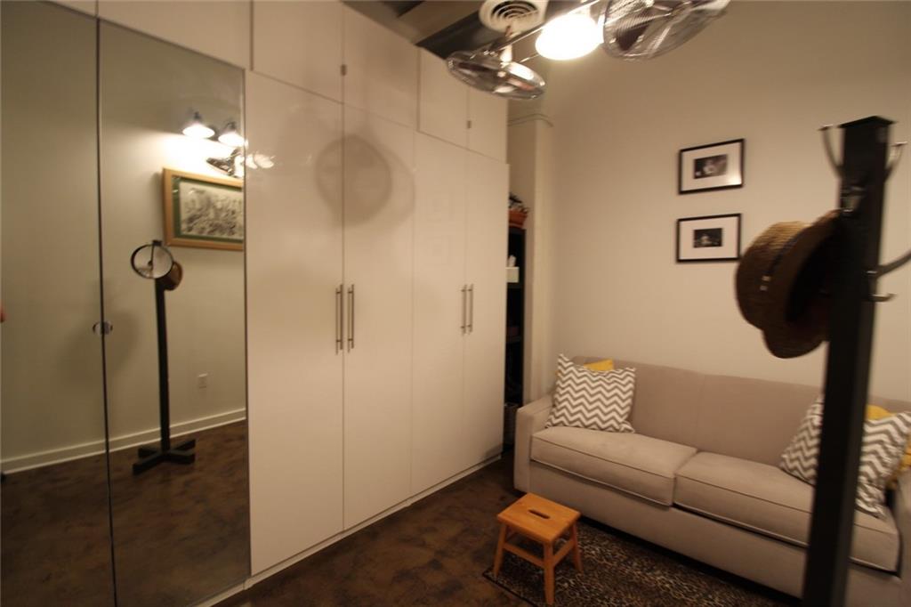 172 Haynes Street Southwest, Unit 208 Atlanta, GA 30313 - Photo 3 of 30 a living room with furniture and a walk in closet