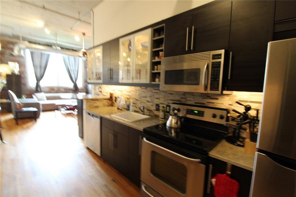172 Haynes Street Southwest, Unit 208 Atlanta, GA 30313 - Photo 8 of 30 a kitchen with a stove and a microwave