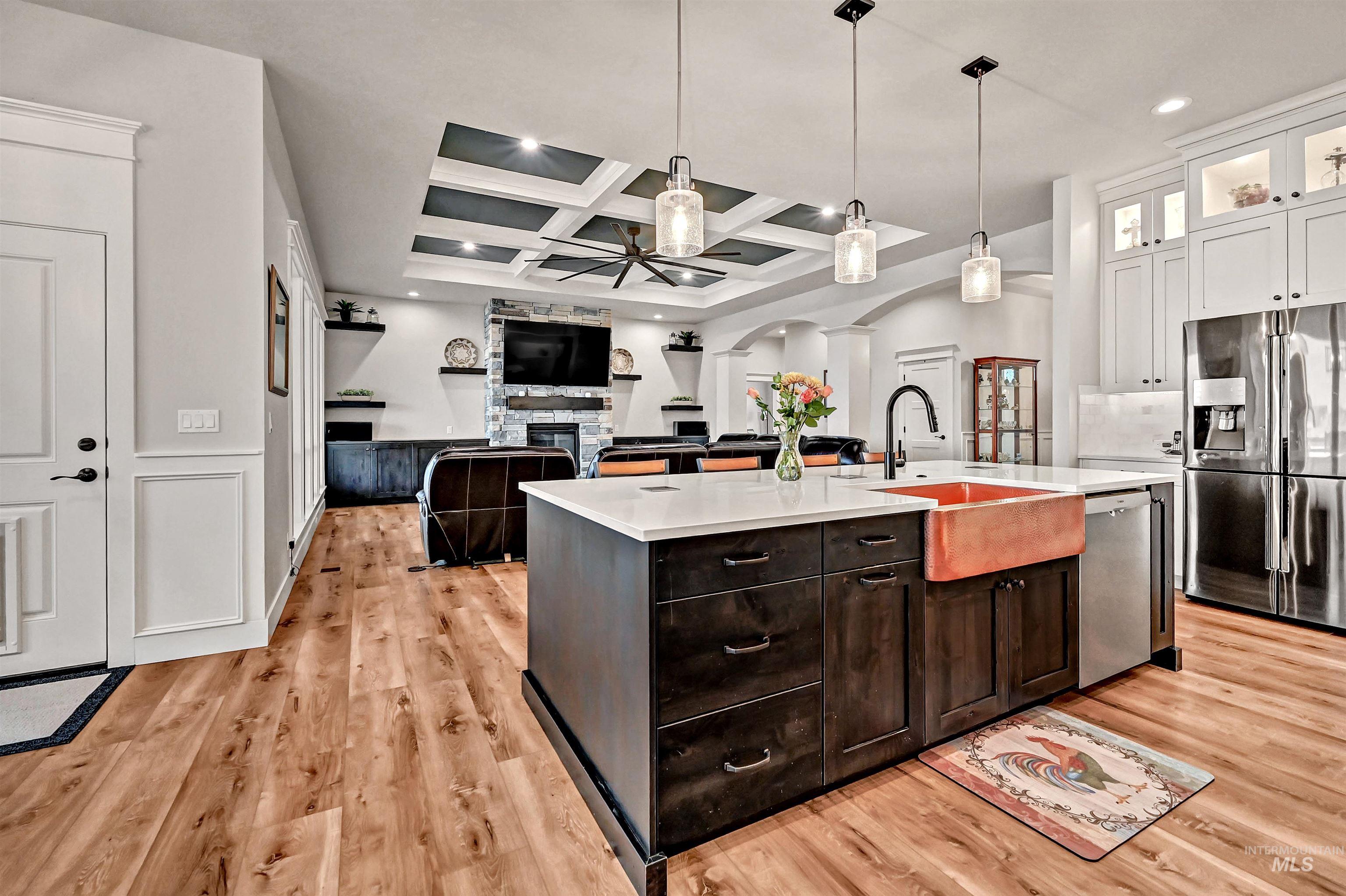 14964 Mortensen Court Caldwell, ID 83607 - Photo 38 of 38 Kitchen with coffered ceiling, stainless steel appliances, hanging light fixtures, glass insert cabinets, and open floor plan