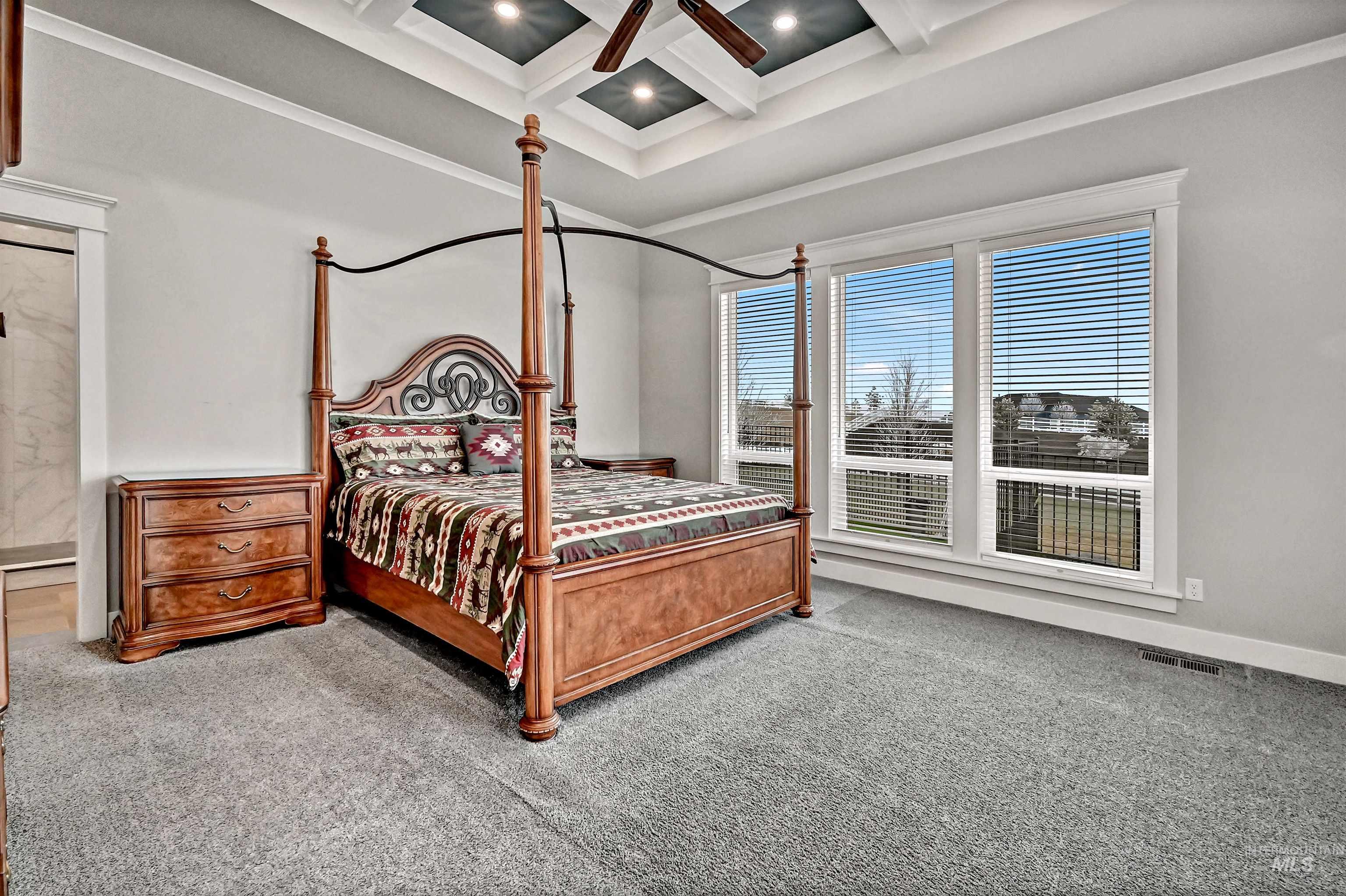 14964 Mortensen Court Caldwell, ID 83607 - Photo 20 of 38 Bedroom featuring coffered ceiling, beam ceiling, carpet, and ceiling fan
