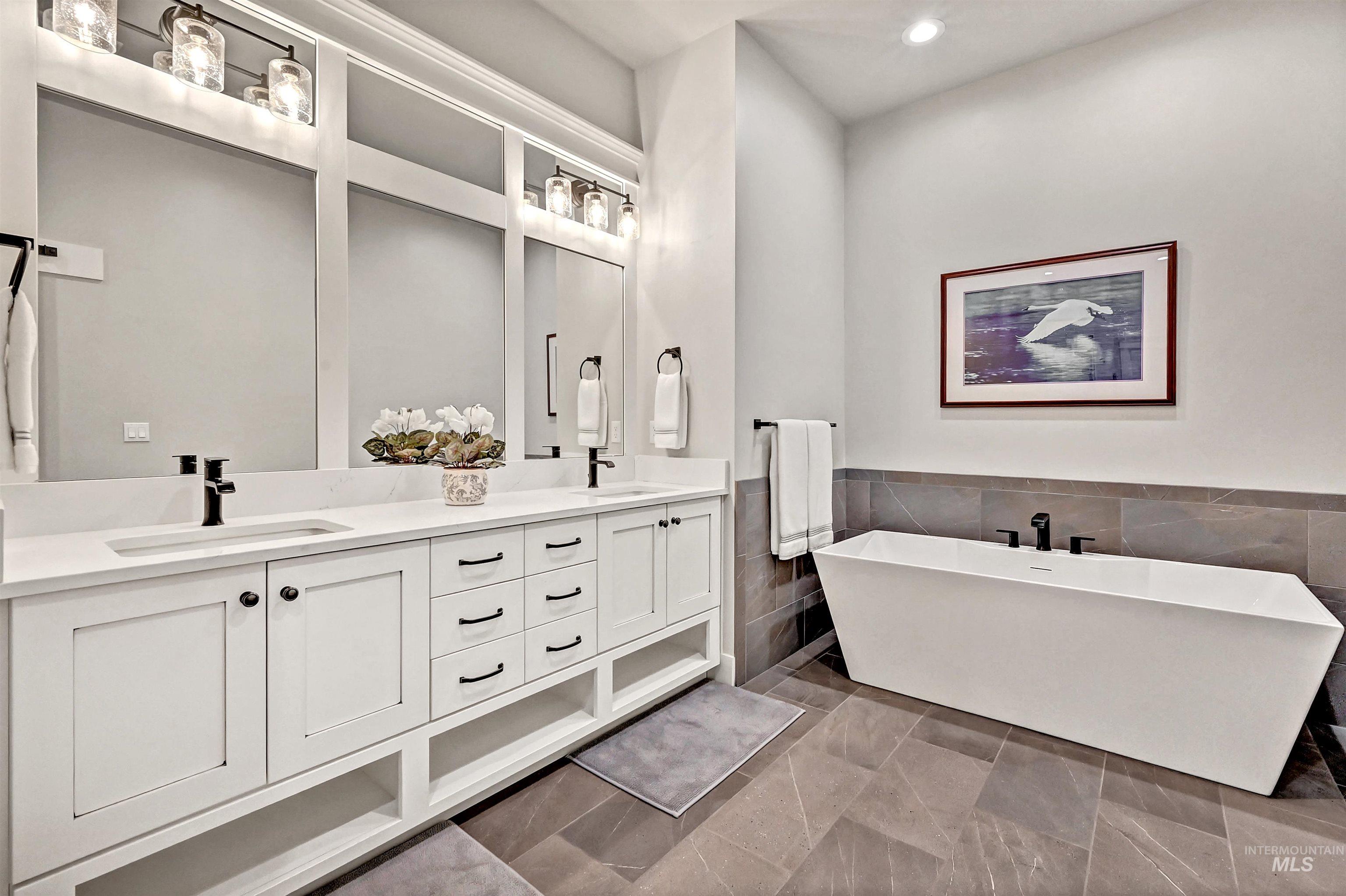 14964 Mortensen Court Caldwell, ID 83607 - Photo 22 of 38 Full bath featuring a freestanding bath, tile walls, a wainscoted wall, double vanity, and recessed lighting