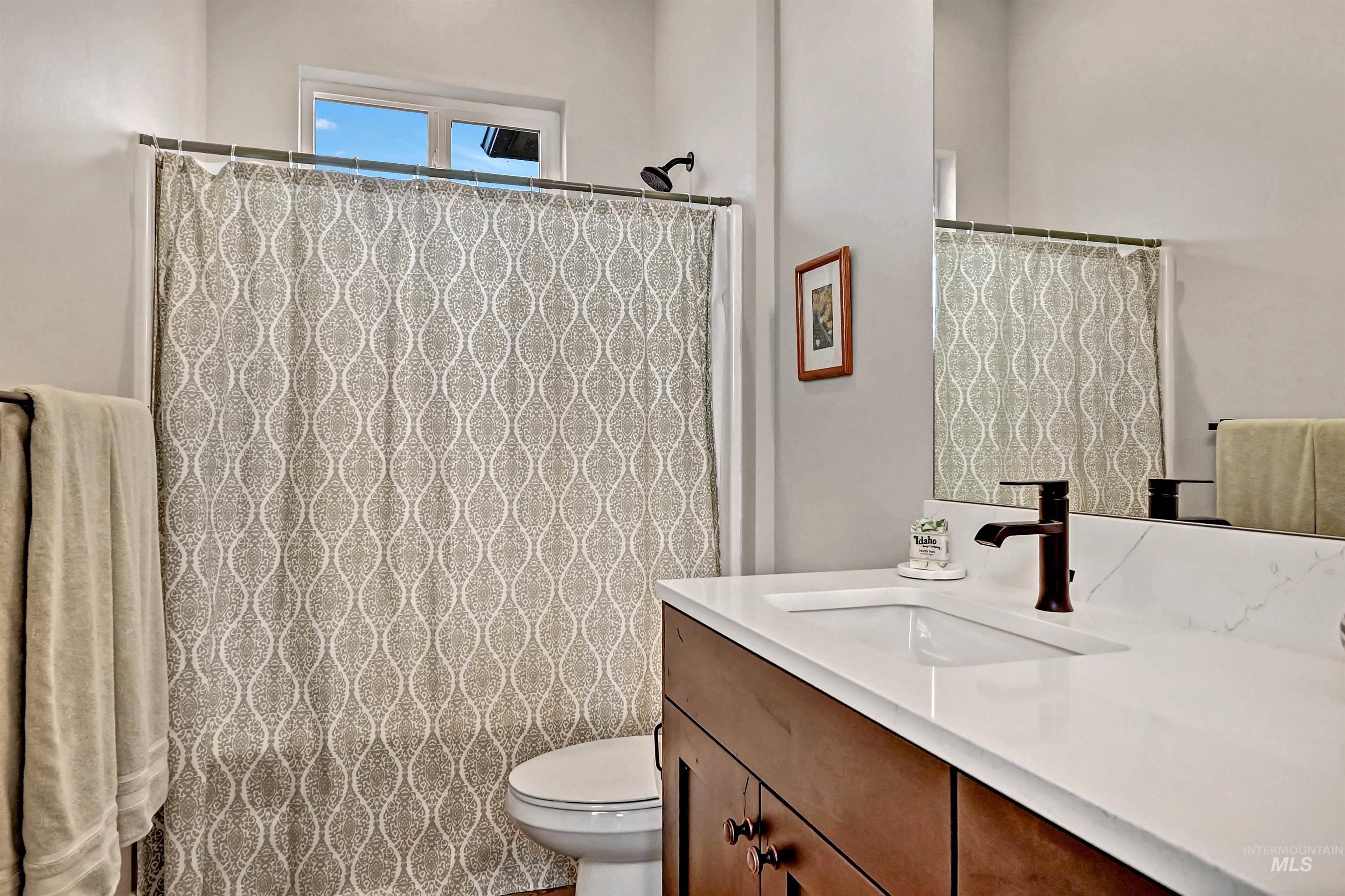 14964 Mortensen Court Caldwell, ID 83607 - Photo 26 of 38 Bathroom with vanity and curtained shower