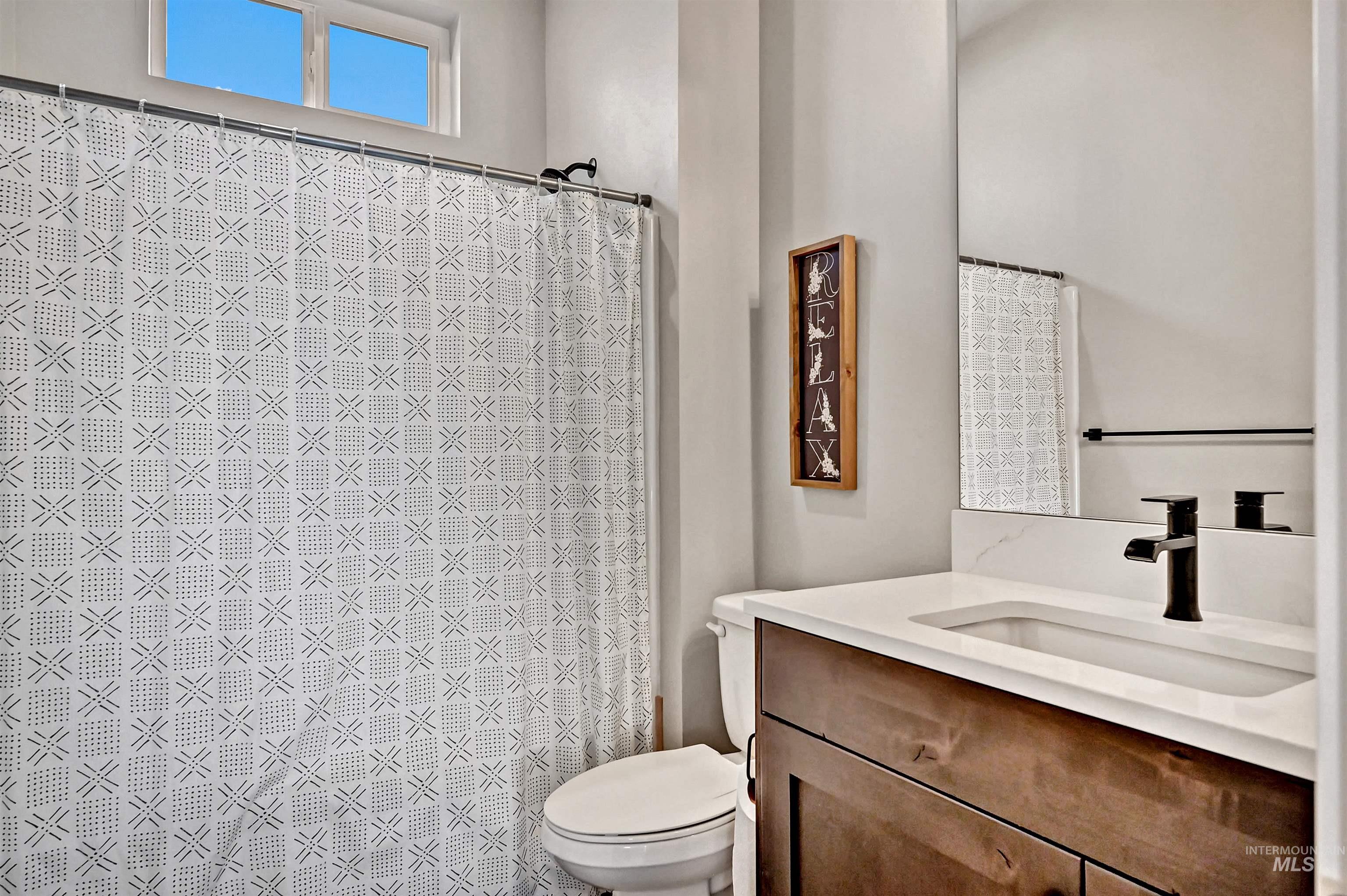 14964 Mortensen Court Caldwell, ID 83607 - Photo 28 of 38 Full bath with vanity and a shower with curtain