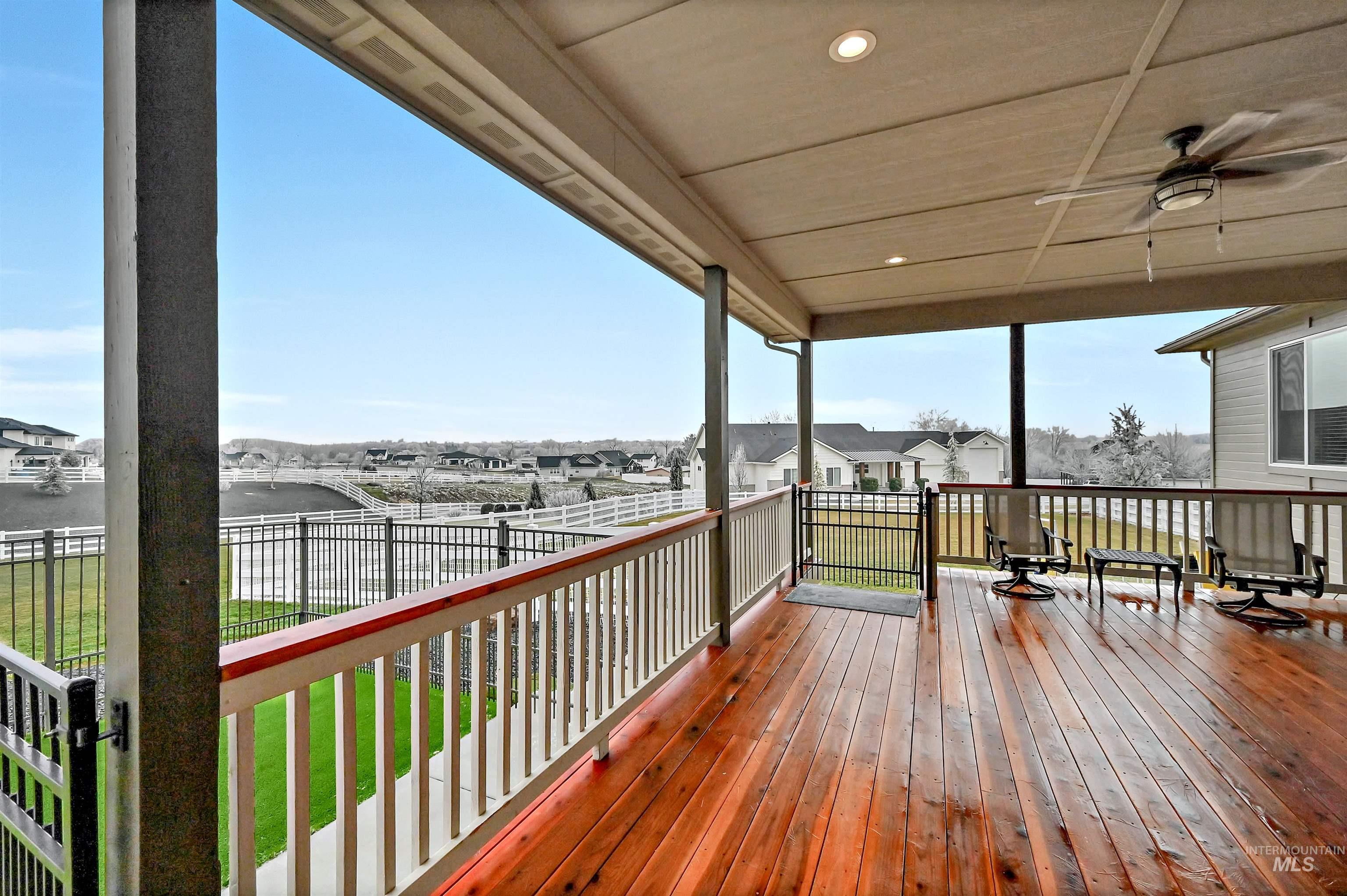14964 Mortensen Court Caldwell, ID 83607 - Photo 30 of 38 Wooden deck with a residential view, a yard, and a ceiling fan