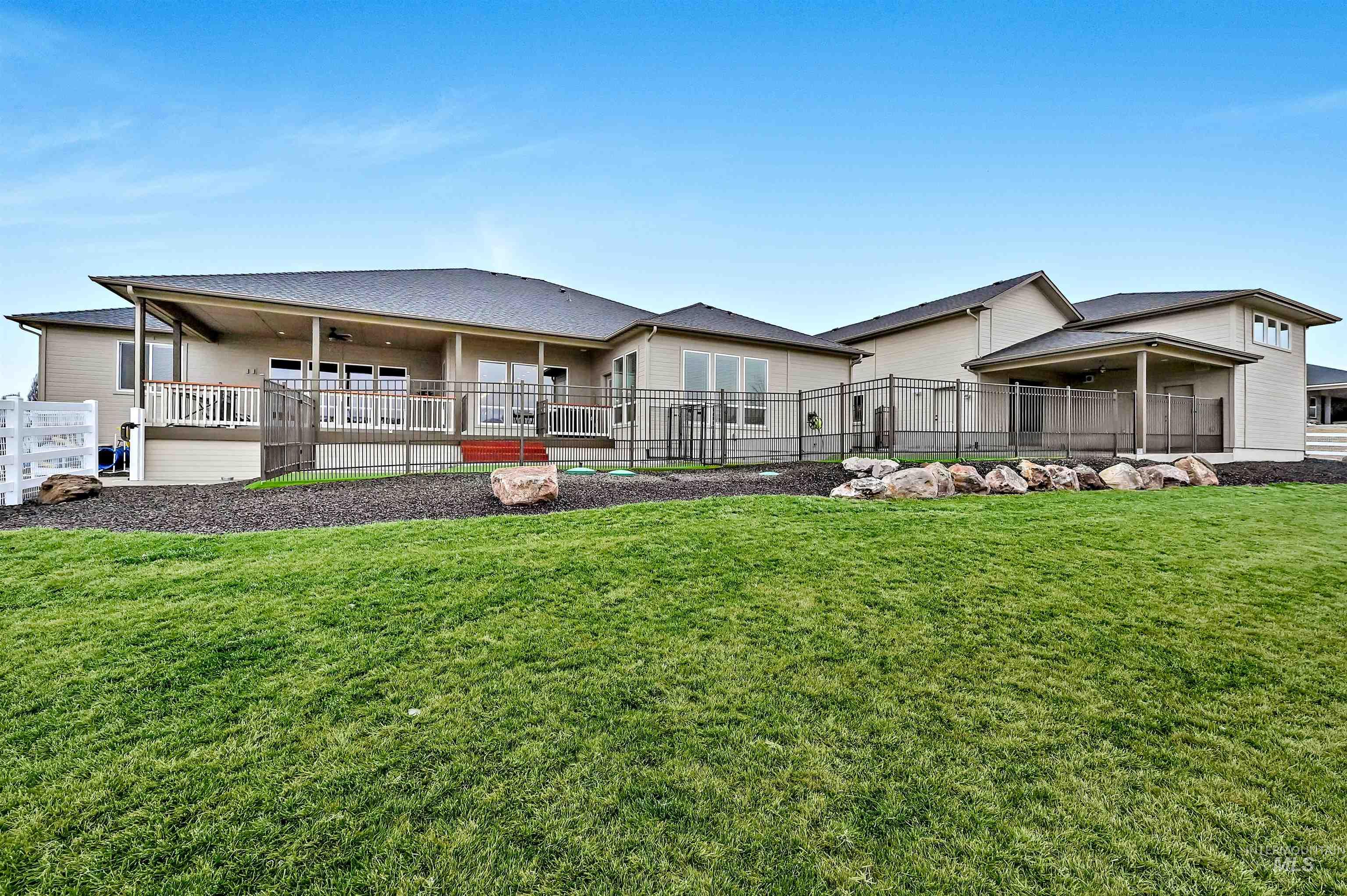 14964 Mortensen Court Caldwell, ID 83607 - Photo 32 of 38 Back of property featuring a ceiling fan and covered porch