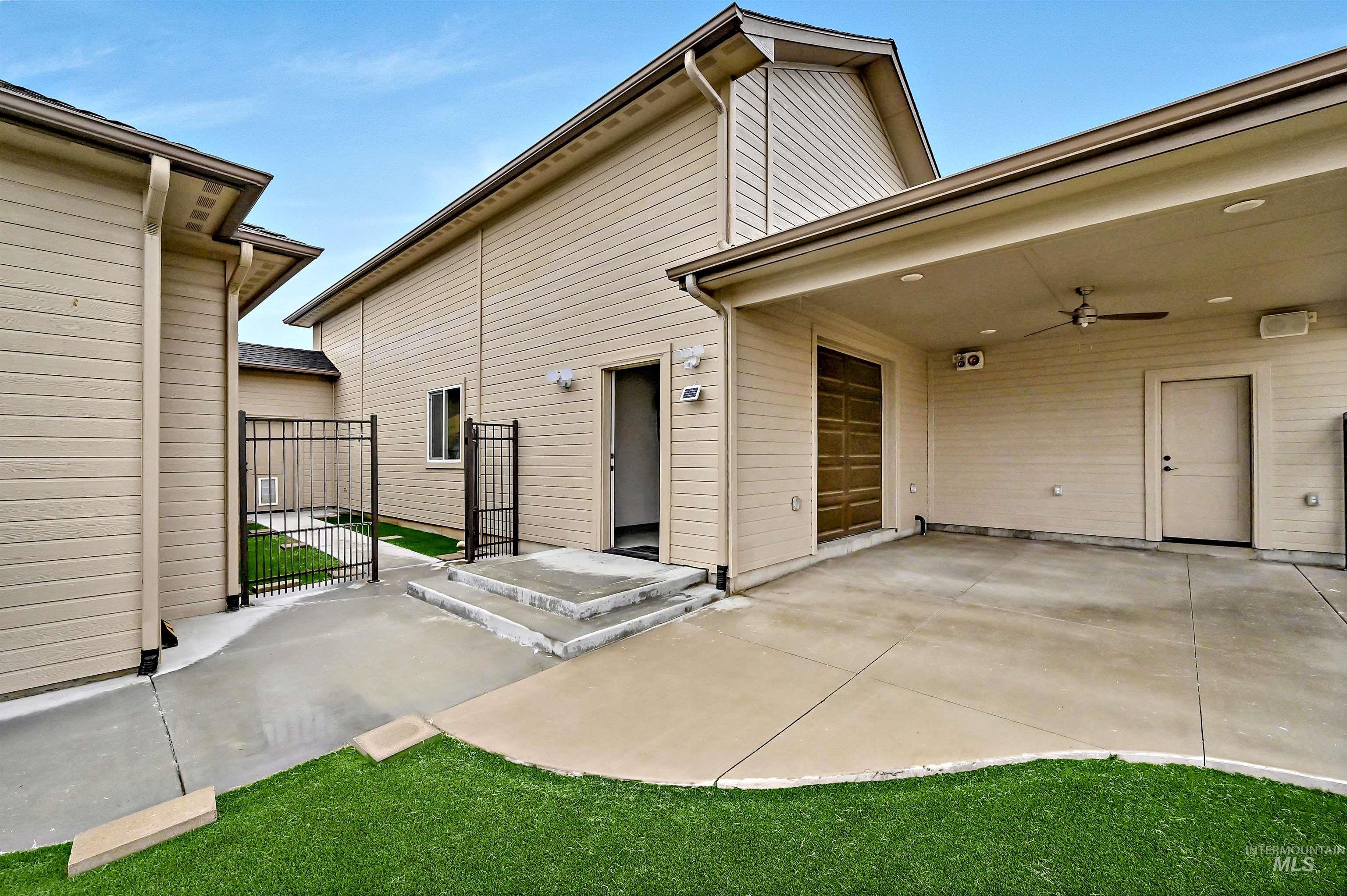 14964 Mortensen Court Caldwell, ID 83607 - Photo 35 of 38 Rear view of house featuring a patio area, a gate, and ceiling fan