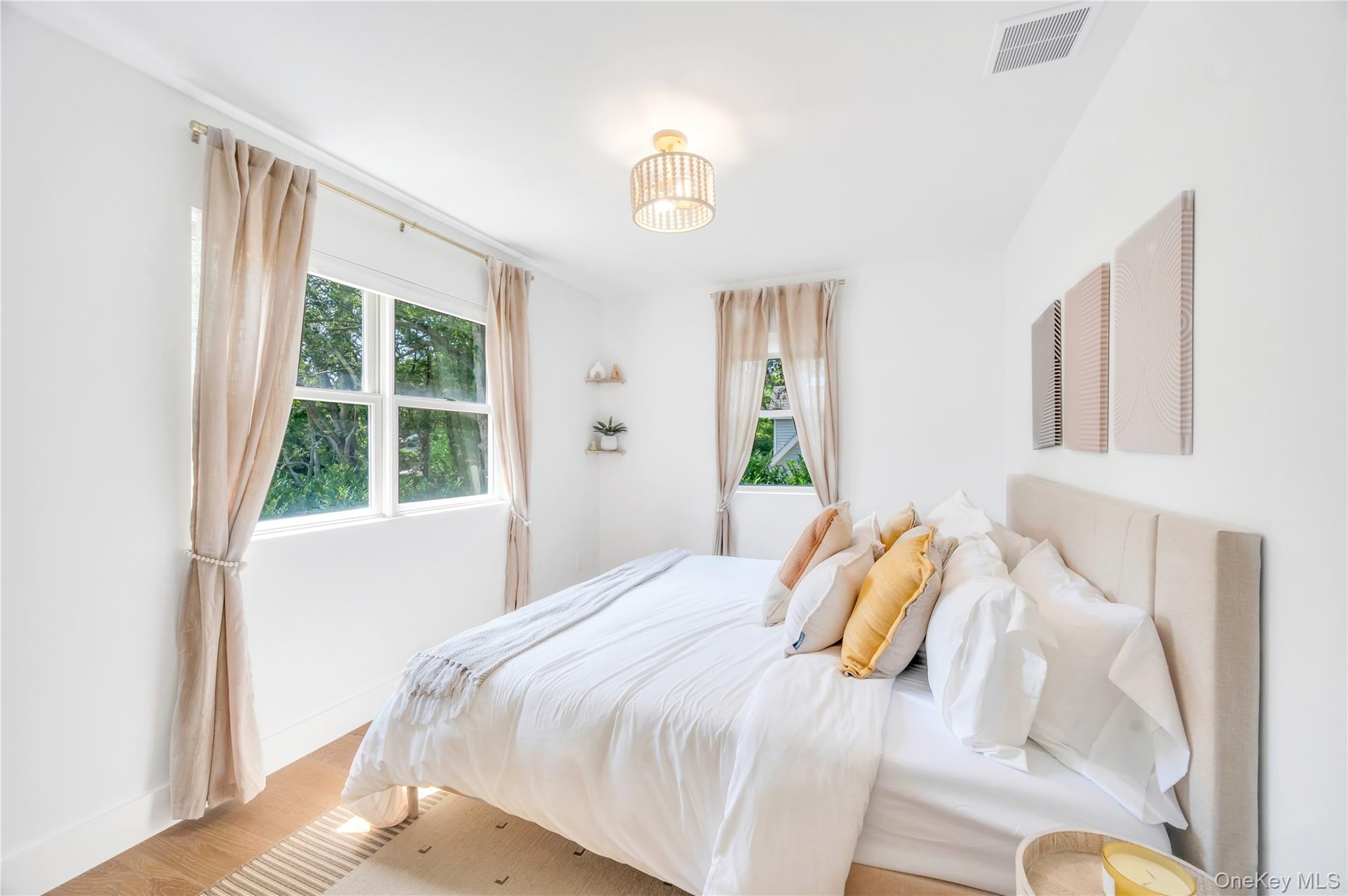 9 Pine Tree Road Southampton, NY 11968 - Photo 12 of 20 a bedroom with a bed and a window