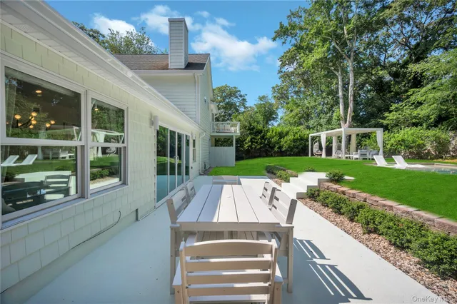 a view of a patio with couches chairs and backyard