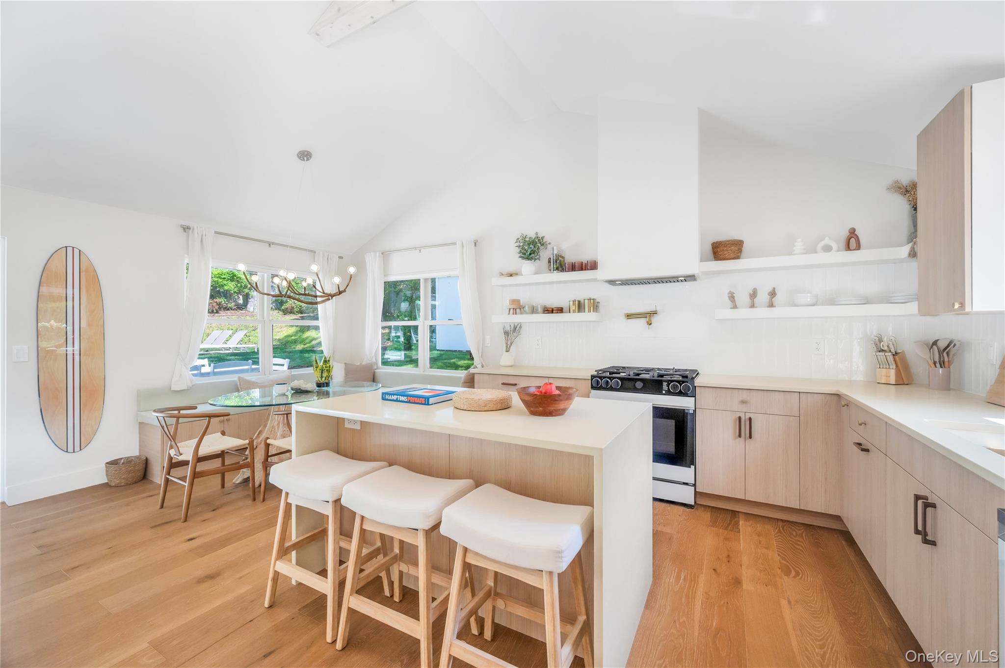 9 Pine Tree Road Southampton, NY 11968 - Photo 5 of 20 a kitchen with stainless steel appliances a stove a sink dishwasher and white cabinets with wooden floor