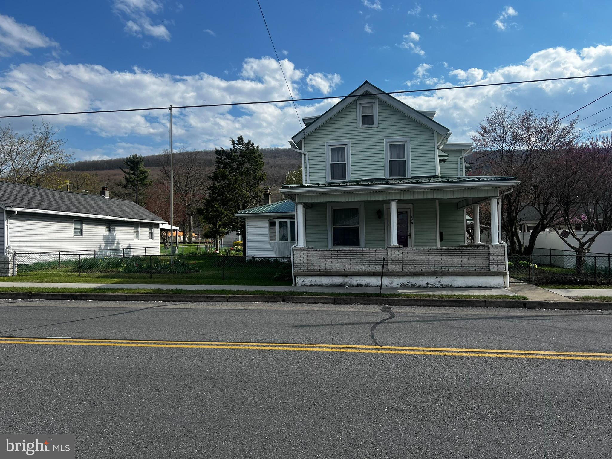 128 Main Street Lykens, PA 17048 - Photo 2 of 28 a front view of a house with a garden