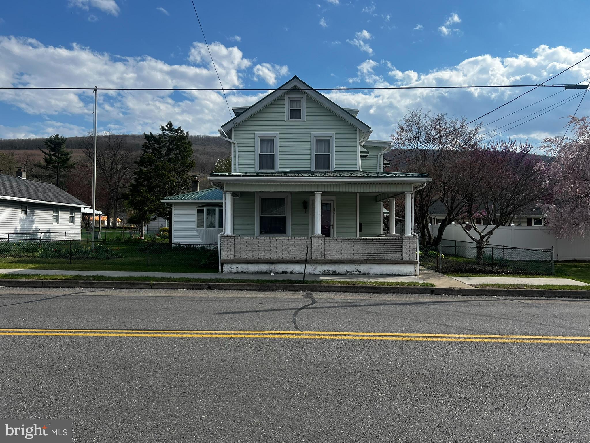128 Main Street Lykens, PA 17048 - Photo 4 of 28 a front view of a house with a garden and plants