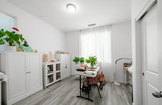 a view of a workspace with furniture and a potted plant