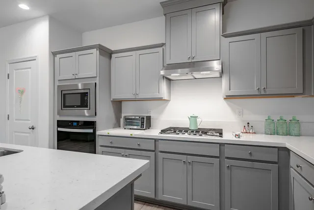 a kitchen with stainless steel appliances granite countertop a refrigerator sink and cabinets