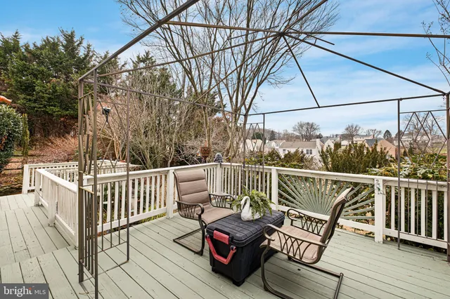 a view of a roof deck with wooden floor and outdoor seating