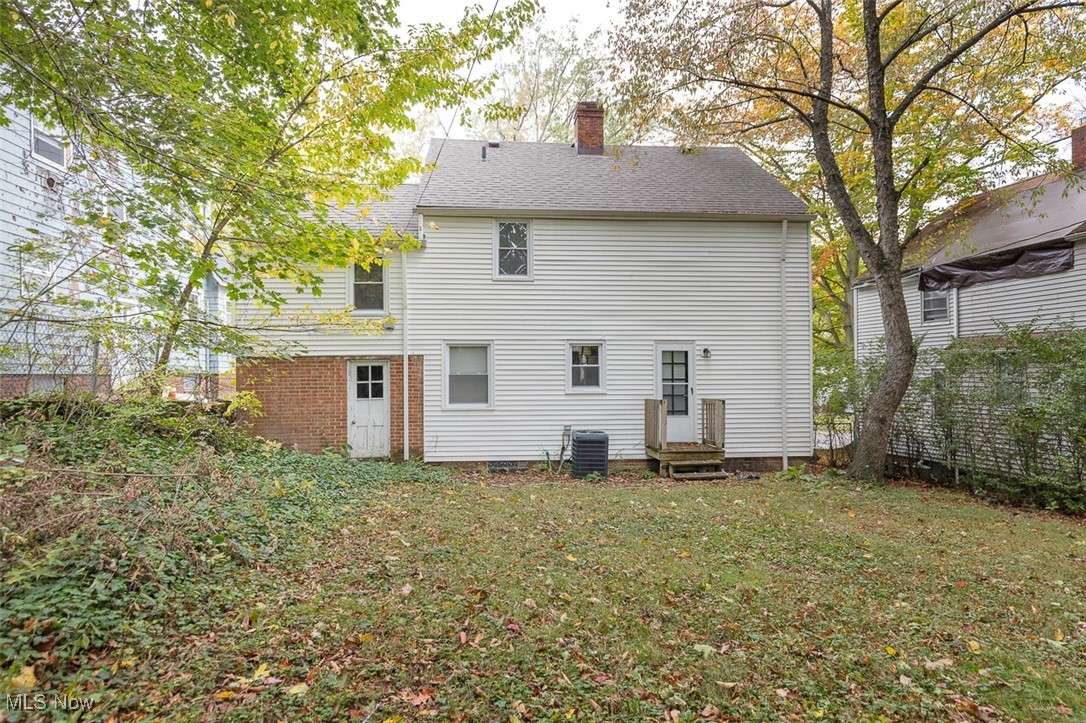 1195 Oxford Road Cleveland, OH 44121 - Photo 31 of 31 Rear view of property with a chimney and a lawn