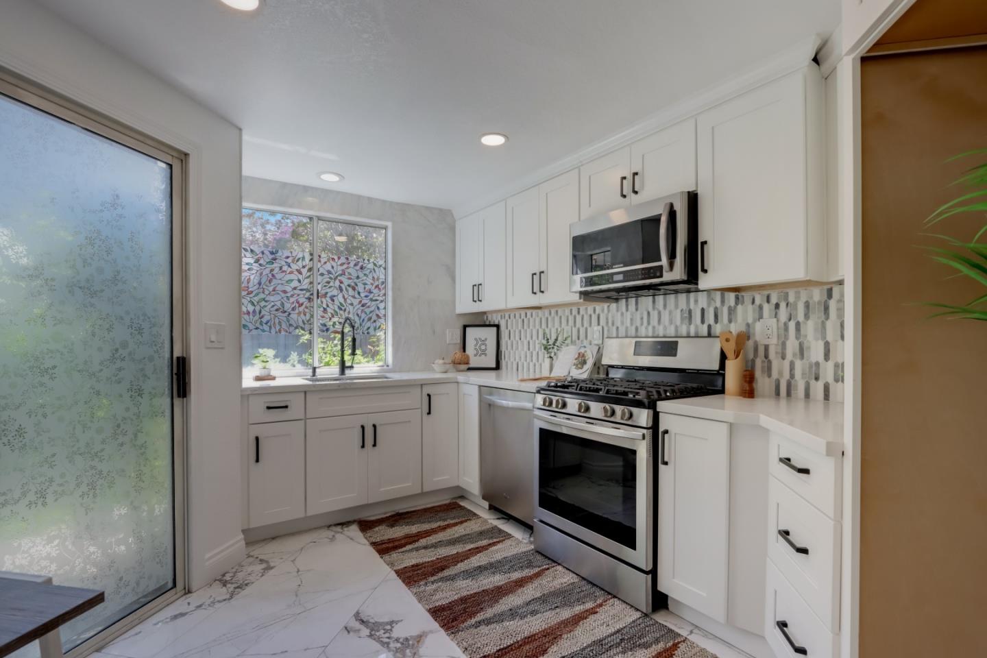 903 Springview Circle San Ramon, CA 94583 - Photo 9 of 41 a kitchen with stainless steel appliances granite countertop a stove a sink and a microwave
