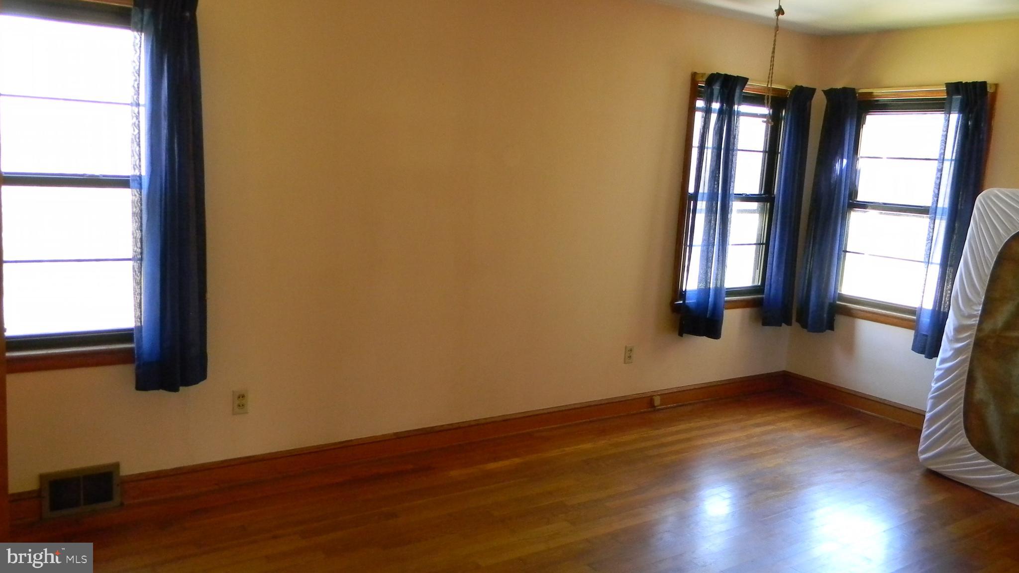 6688 Brocks Gap Road Broadway, VA 22815 - Photo 54 of 81 a view of an empty room with wooden floor and a window