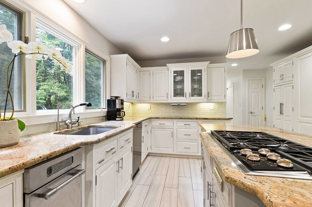 30 Castle Drive Sharon, MA 02067 - Photo 22 of 42 a kitchen with granite countertop a sink stove and cabinets