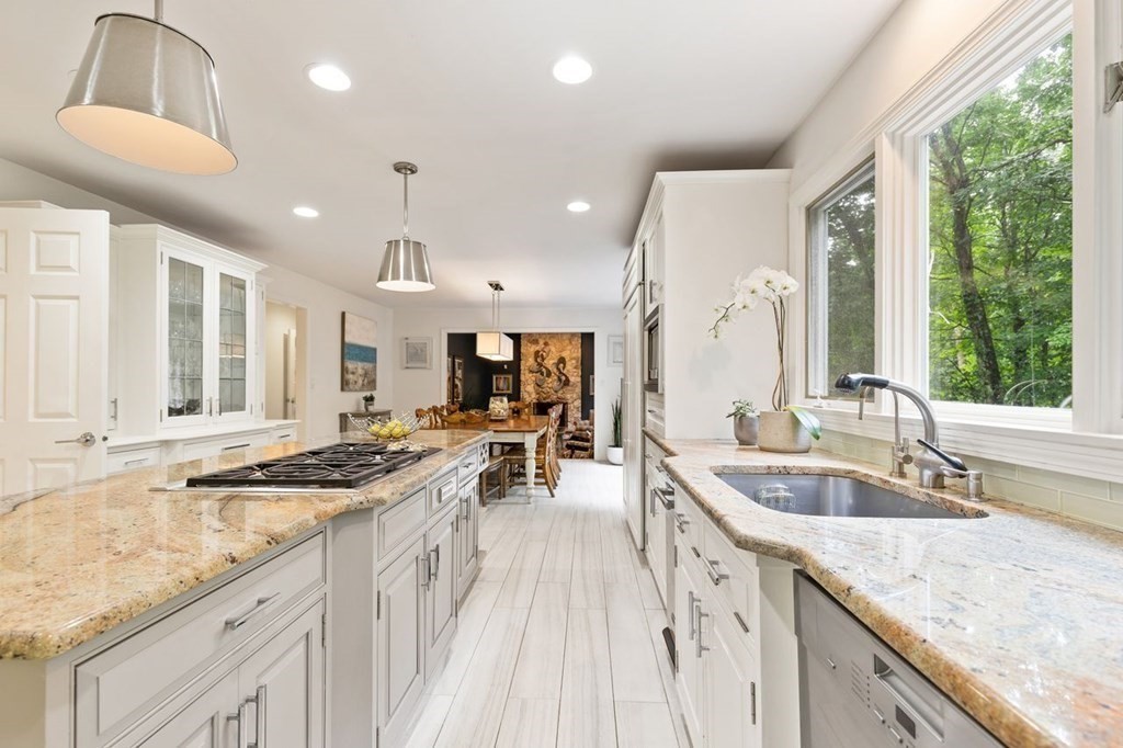 30 Castle Drive Sharon, MA 02067 - Photo 24 of 42 a kitchen with granite countertop a sink stove and cabinets