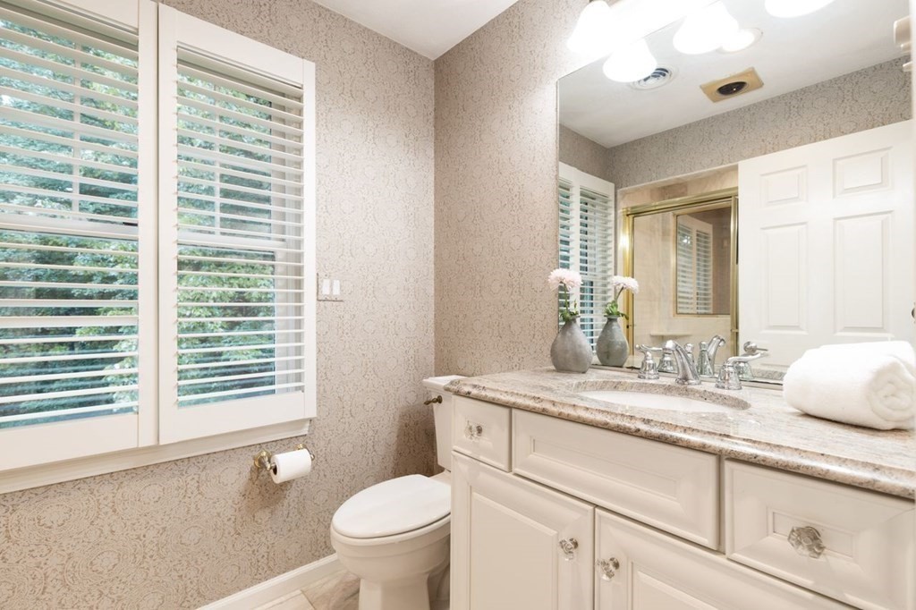 30 Castle Drive Sharon, MA 02067 - Photo 32 of 42 a bathroom with a granite countertop sink toilet and mirror