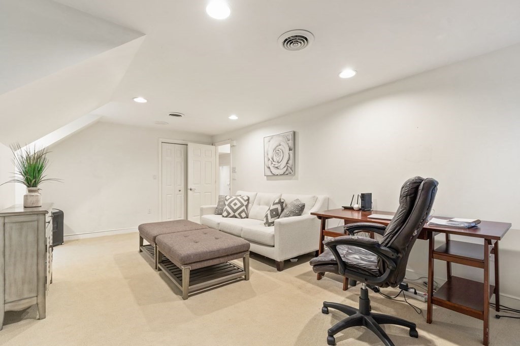 30 Castle Drive Sharon, MA 02067 - Photo 34 of 42 a living room with a couch and a potted plant