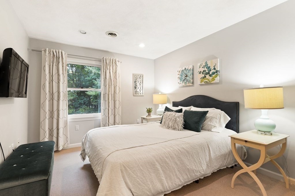 30 Castle Drive Sharon, MA 02067 - Photo 35 of 42 a bedroom with a bed and wooden floor