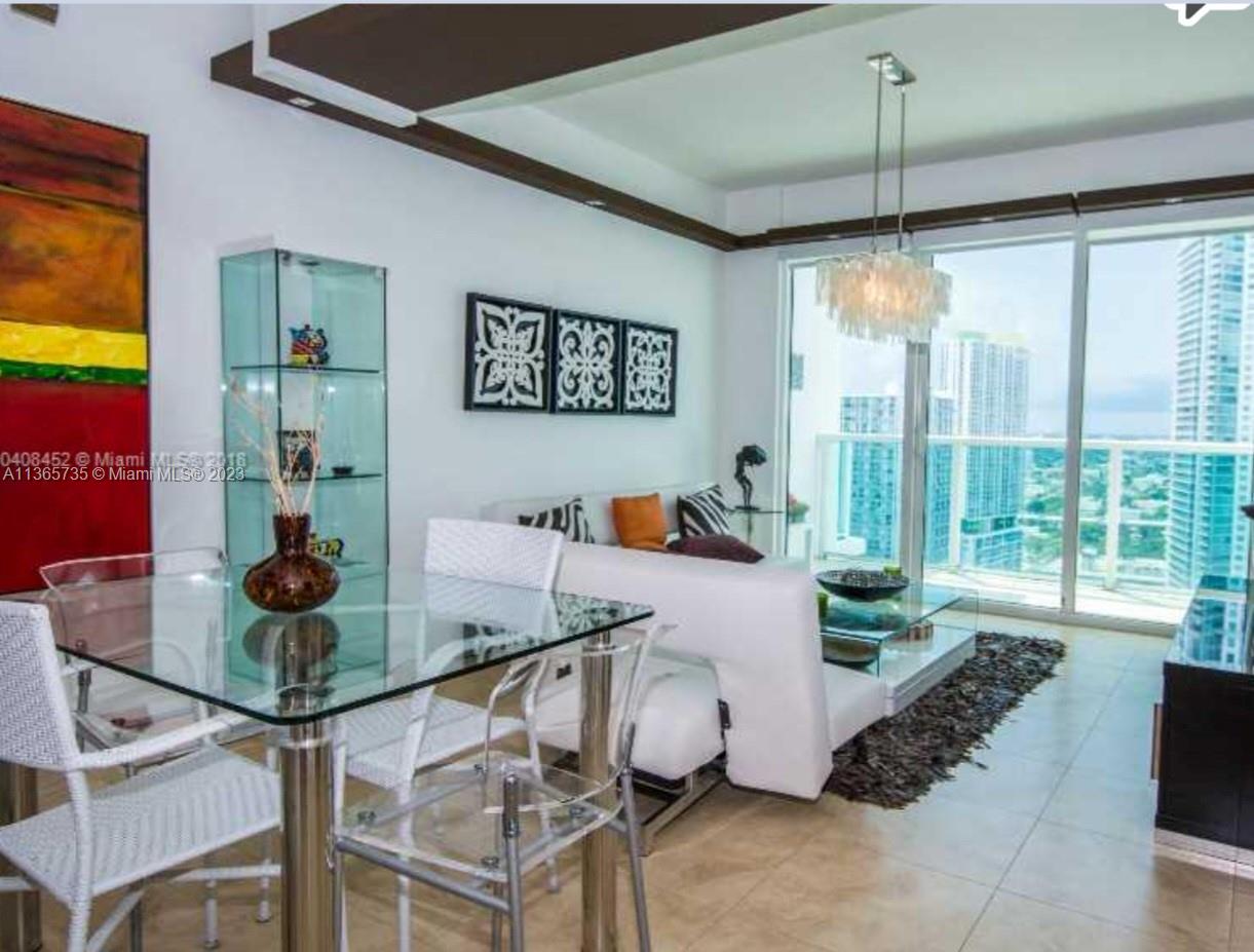 31 Southeast 5th Street, Unit 3309 Miami, FL 33131 - Photo 1 of 15 a living room with furniture and floor to ceiling windows