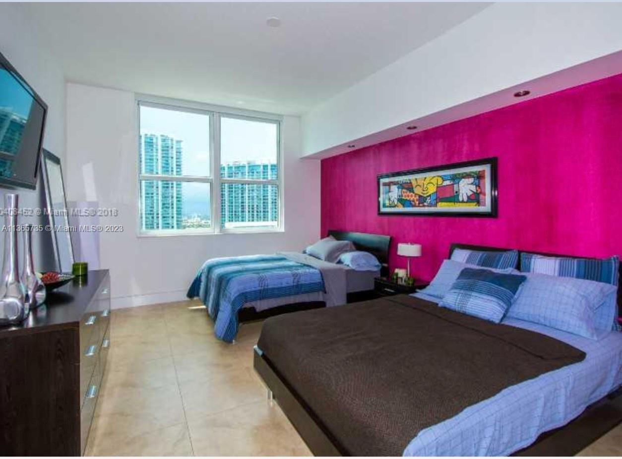 31 Southeast 5th Street, Unit 3309 Miami, FL 33131 - Photo 4 of 15 a bedroom with two beds and a window