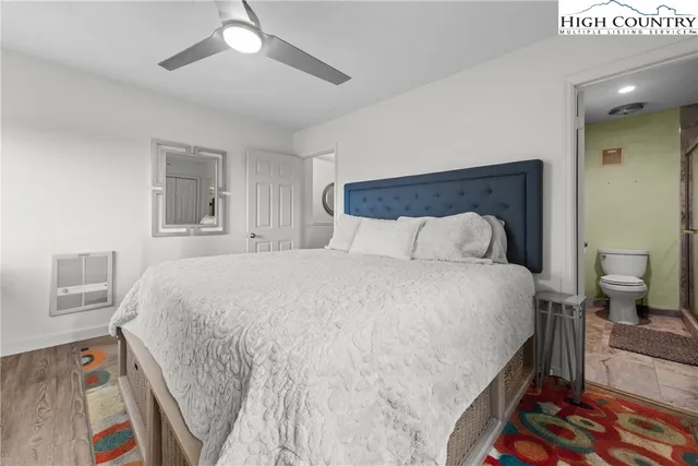 a spacious bedroom with a bed and a dresser