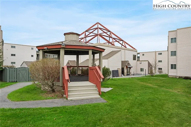 a view of a big yard with large trees