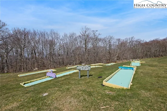 a view of a field with trees in the background