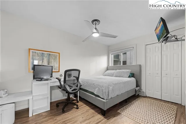 a bedroom with a bed a table and chair