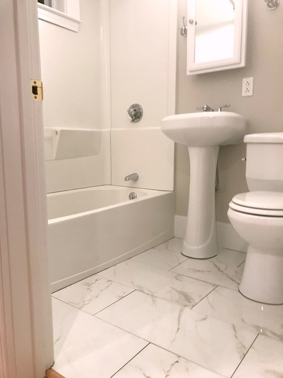 9 Colonial Road Milford, MA 01757 - Photo 12 of 16 a bathroom with a sink a toilet and shower