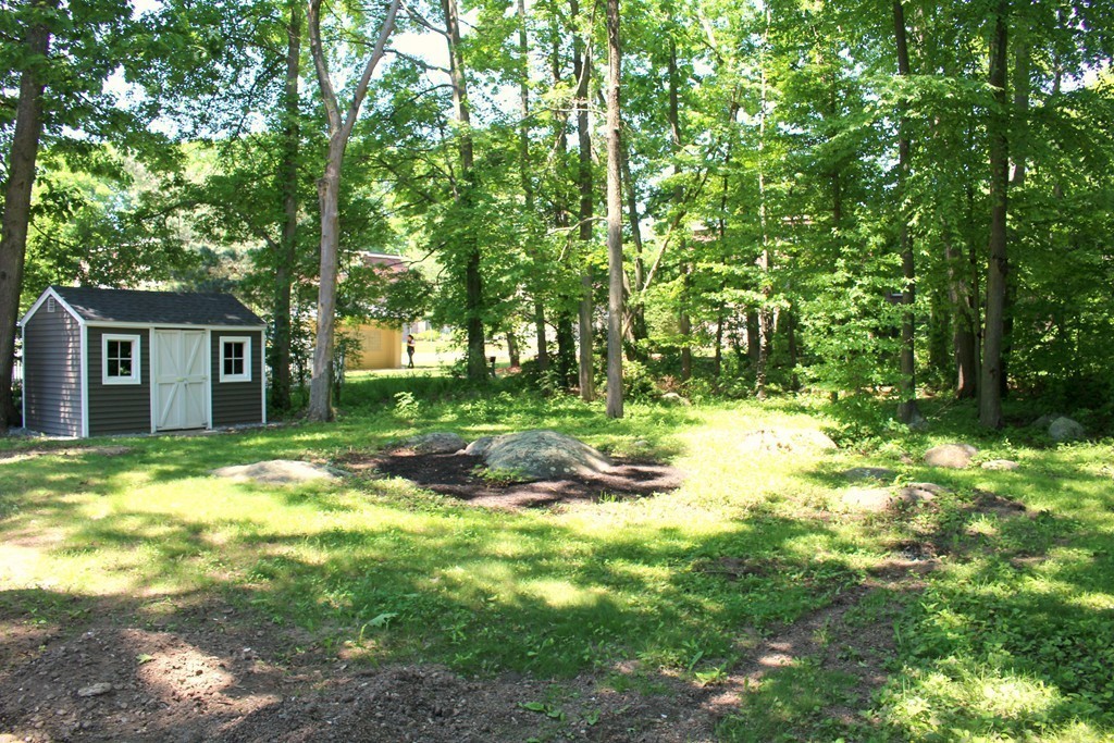 9 Colonial Road Milford, MA 01757 - Photo 14 of 16 a backyard of a house with a yard and outdoor seating