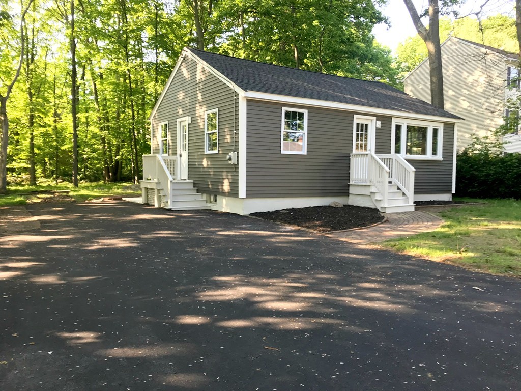 9 Colonial Road Milford, MA 01757 - Photo 2 of 16 a view of a house with backyard and sitting area