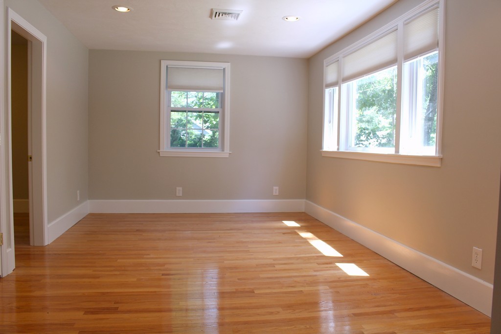 9 Colonial Road Milford, MA 01757 - Photo 3 of 16 a view of an empty room with wooden floor and a window