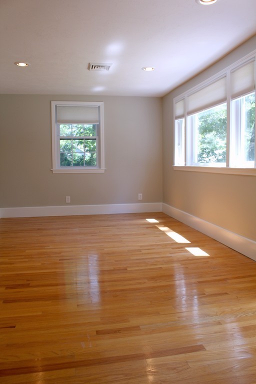 9 Colonial Road Milford, MA 01757 - Photo 4 of 16 an empty room with wooden floor and windows