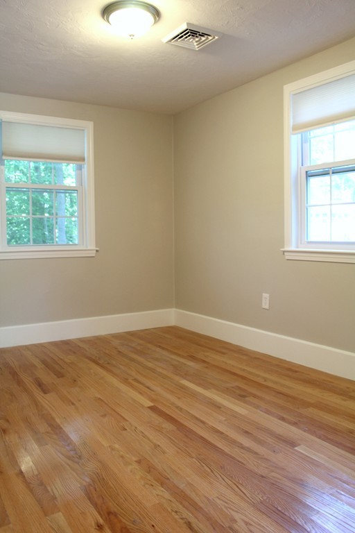 9 Colonial Road Milford, MA 01757 - Photo 5 of 16 a view of an empty room with wooden floor and a window