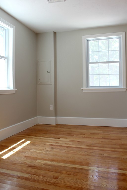 9 Colonial Road Milford, MA 01757 - Photo 6 of 16 a view of an empty room with wooden floor and a window