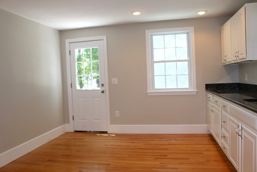 9 Colonial Road Milford, MA 01757 - Photo 9 of 16 an empty room with wooden floor and windows
