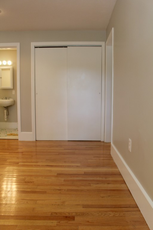 9 Colonial Road Milford, MA 01757 - Photo 10 of 16 a view of empty room with wooden floor