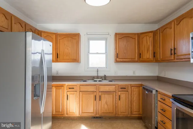 a kitchen with a sink cabinets and appliances