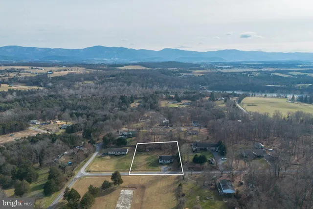 a front view of a house with a garden and trees