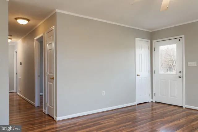 a view of an empty room with wooden floor