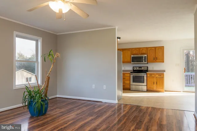 a view of kitchen with sink and refrigerator