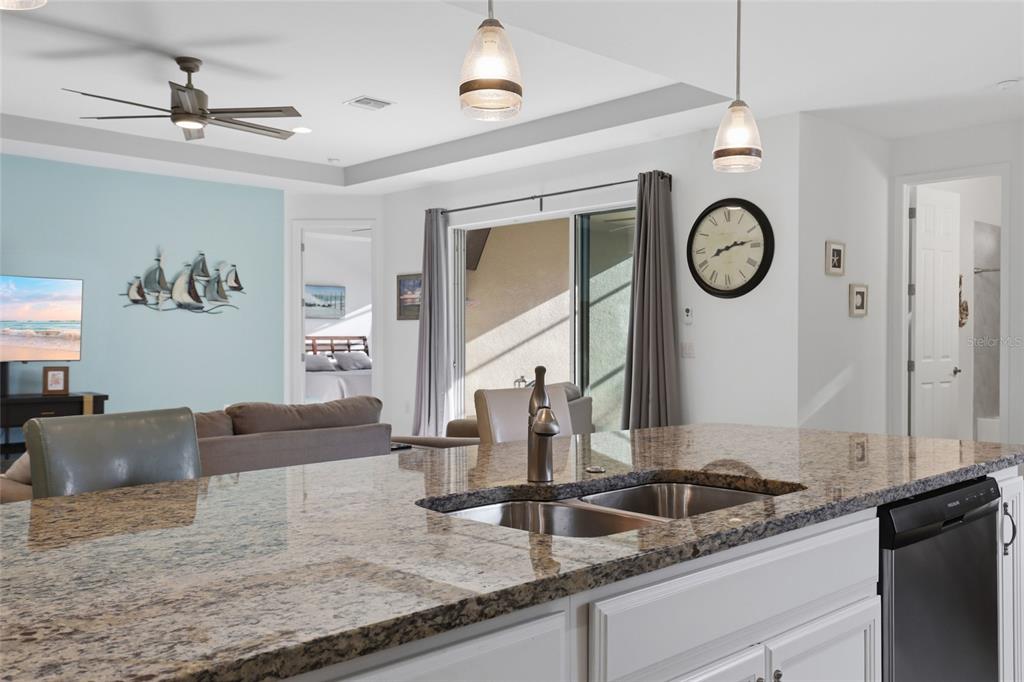 14879 Wichita Road Port Charlotte, FL 33981 - Photo 13 of 45 a living room with granite countertop furniture a fireplace and a window