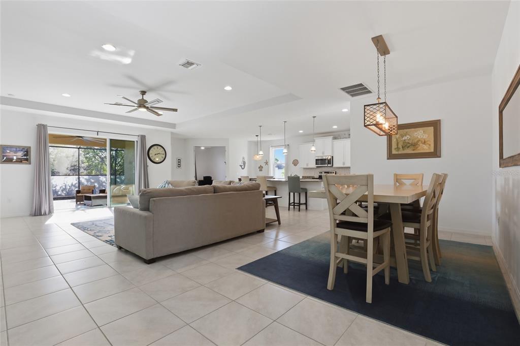 14879 Wichita Road Port Charlotte, FL 33981 - Photo 14 of 45 a living room with furniture a dining table and a rug